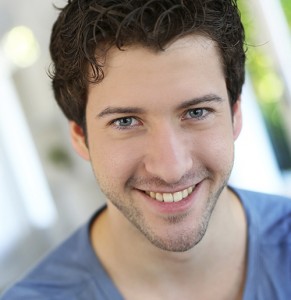 Portrait of cheerful young guy with blue eyes