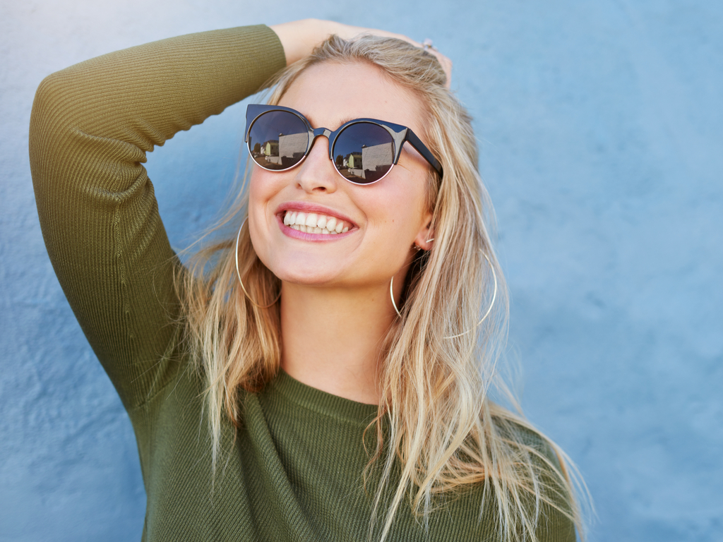 Girl with a bright smile shows off her shiny new veneers.