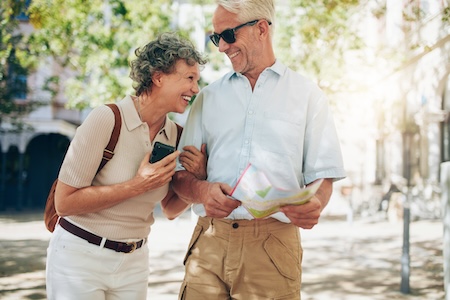 older couple walking cheerfully through town